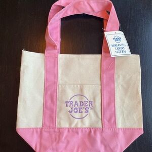 NWT Trader Joe’s pink mini canvas tote. Front pockets on both sides.